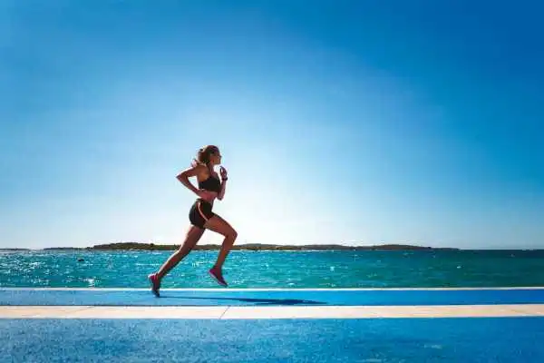 Woman running showing strong leg muscle Kings Norton